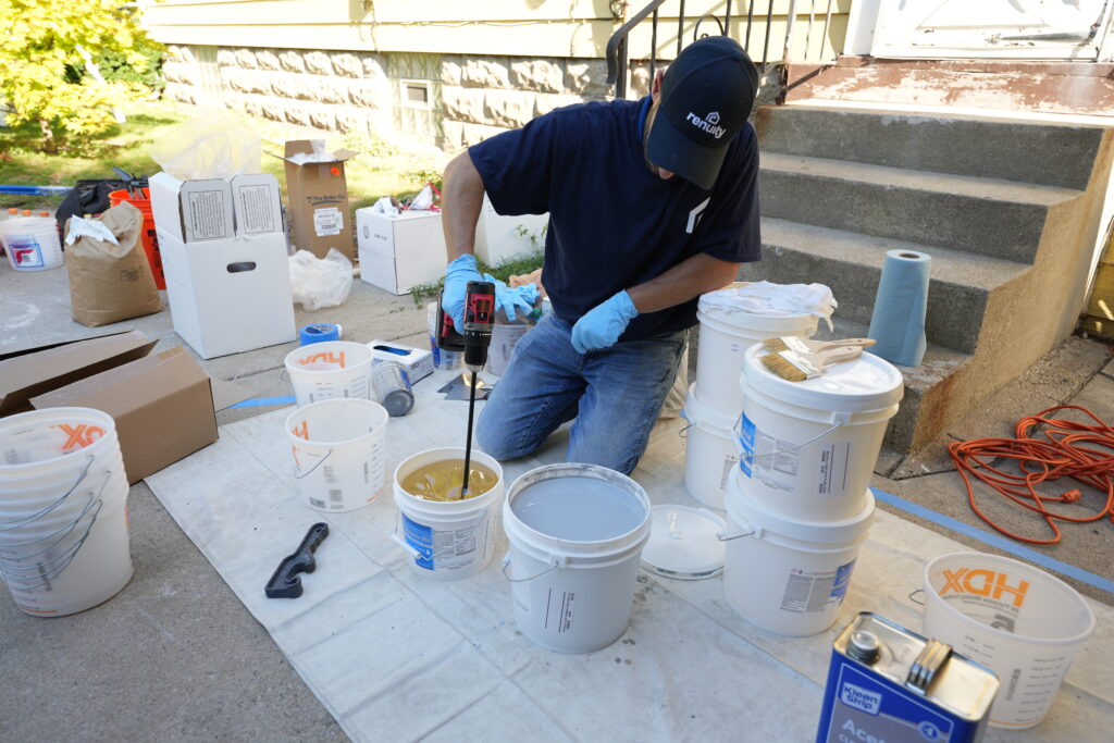 renuity employee preparing topcoat for a floor coating