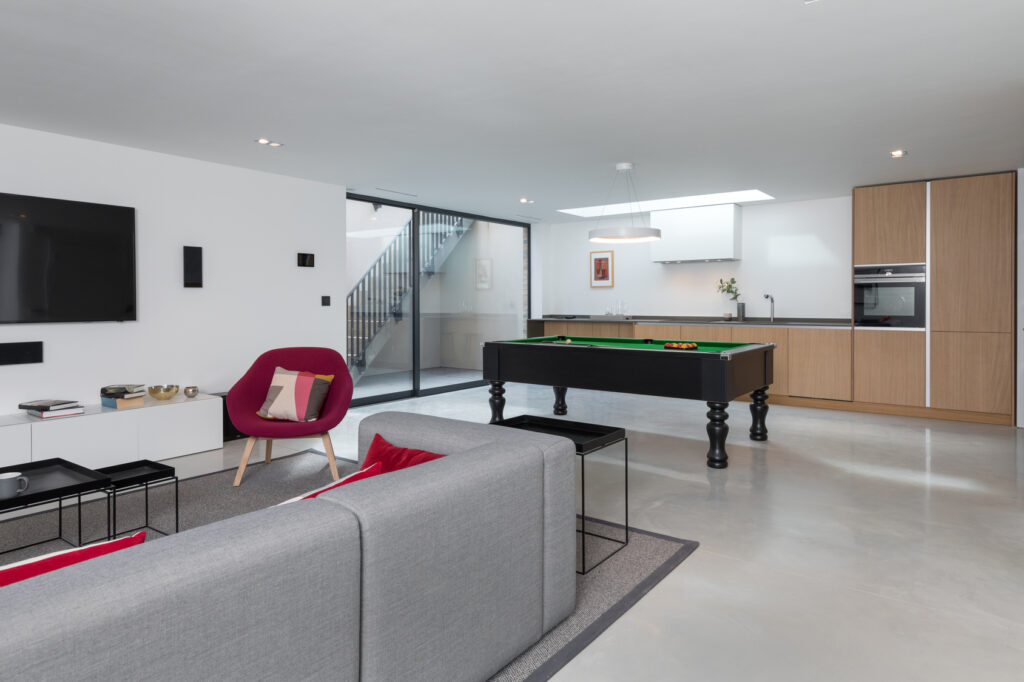 basement with storage cabinets and living room
