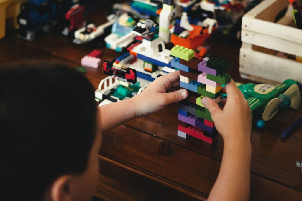 child playing with LEGO bricks