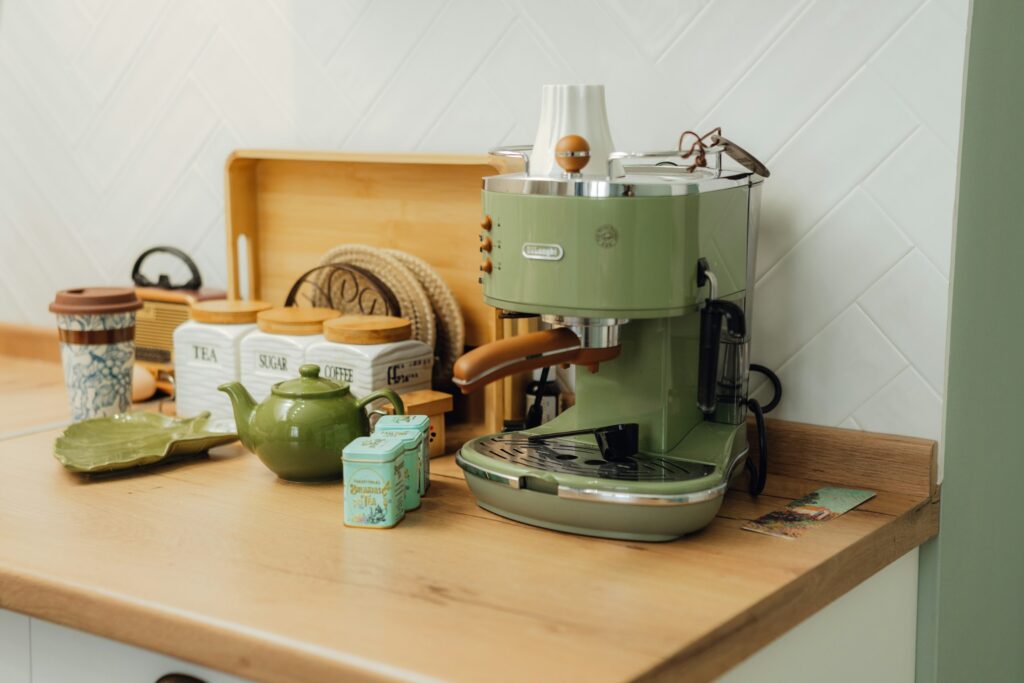 Green mixer next to spices and other kitchen accessories