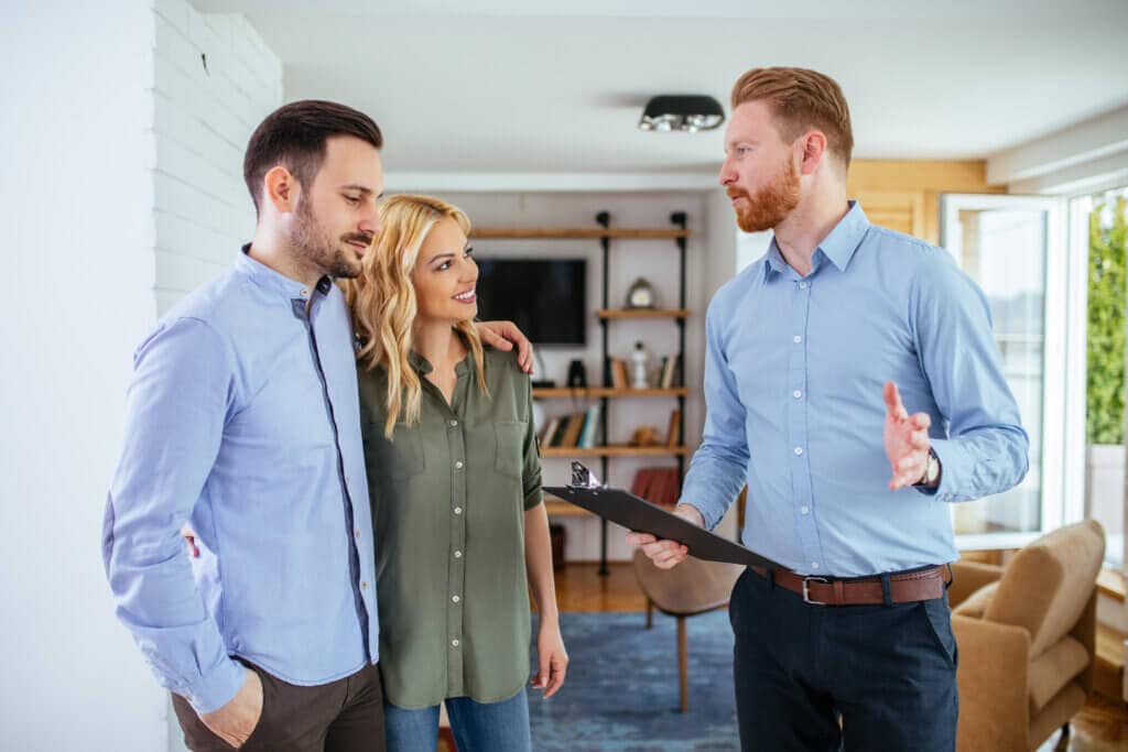 Photo of a young couple counseling with bathroom remodeling contractor at home.