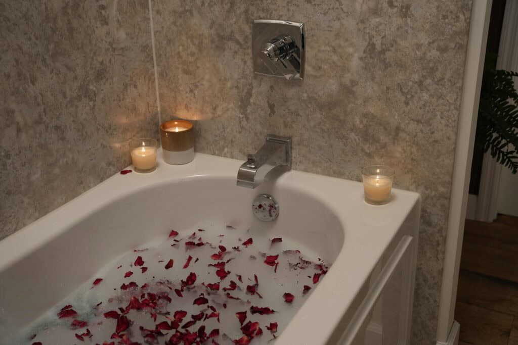 bathtub with candles and rose petals|bathroom remodel|bathroom accessories and flowers|lavender|zen bathtub||